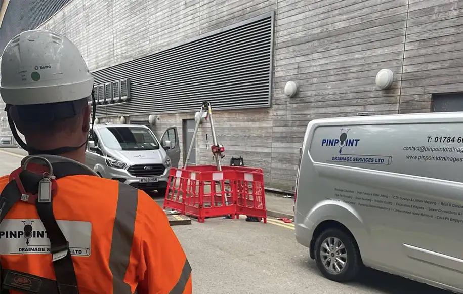 Pinpoint Drainage Services engineer supervising confined space drainage works at a commercial property.
