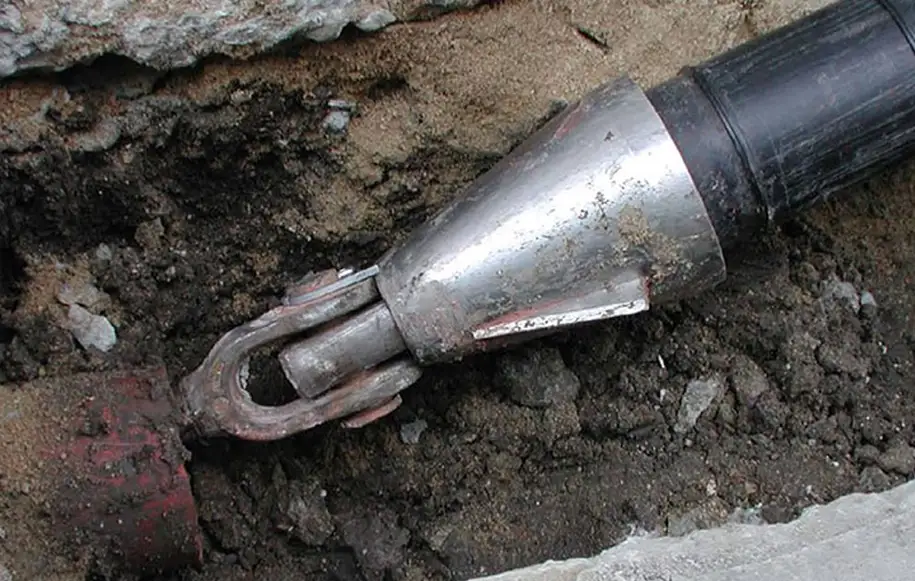 Specialist pipe re-rounding equipment restoring a deformed underground drain pipe to its original shape.